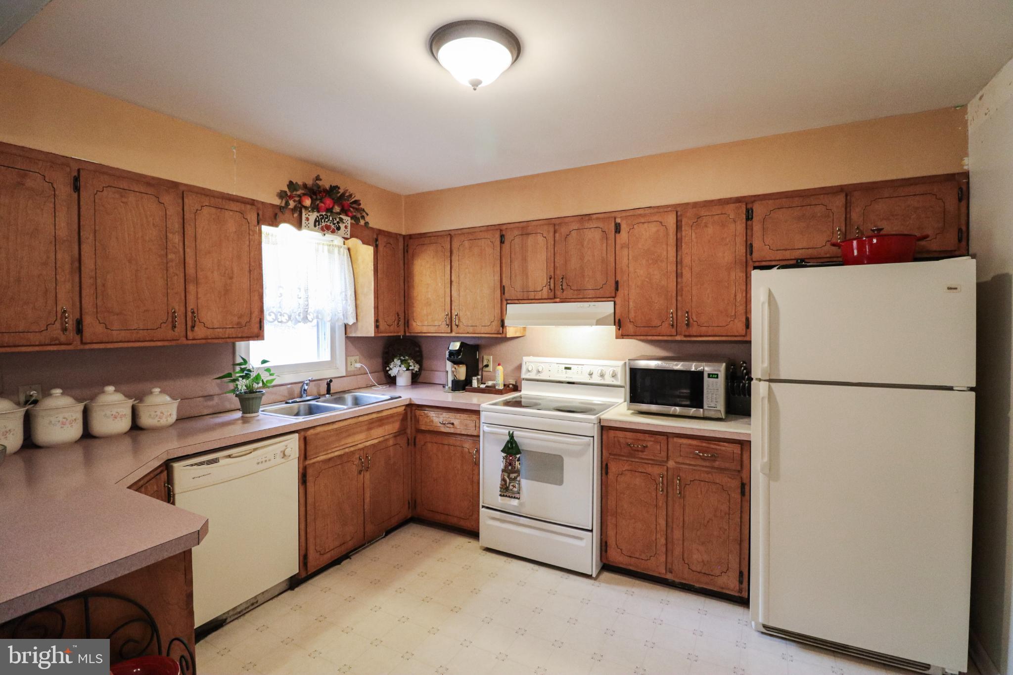 92 Newman Road Orrtanna, PA 17353 - Photo 16 of 42 Cozy kitchen with warm wooden cabinetry.