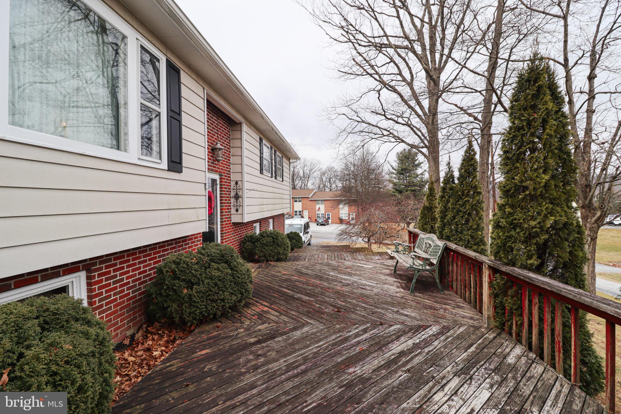 92 Newman Road Orrtanna, PA 17353 - Photo 5 of 42 Charming deck with lush greenery awaits.
