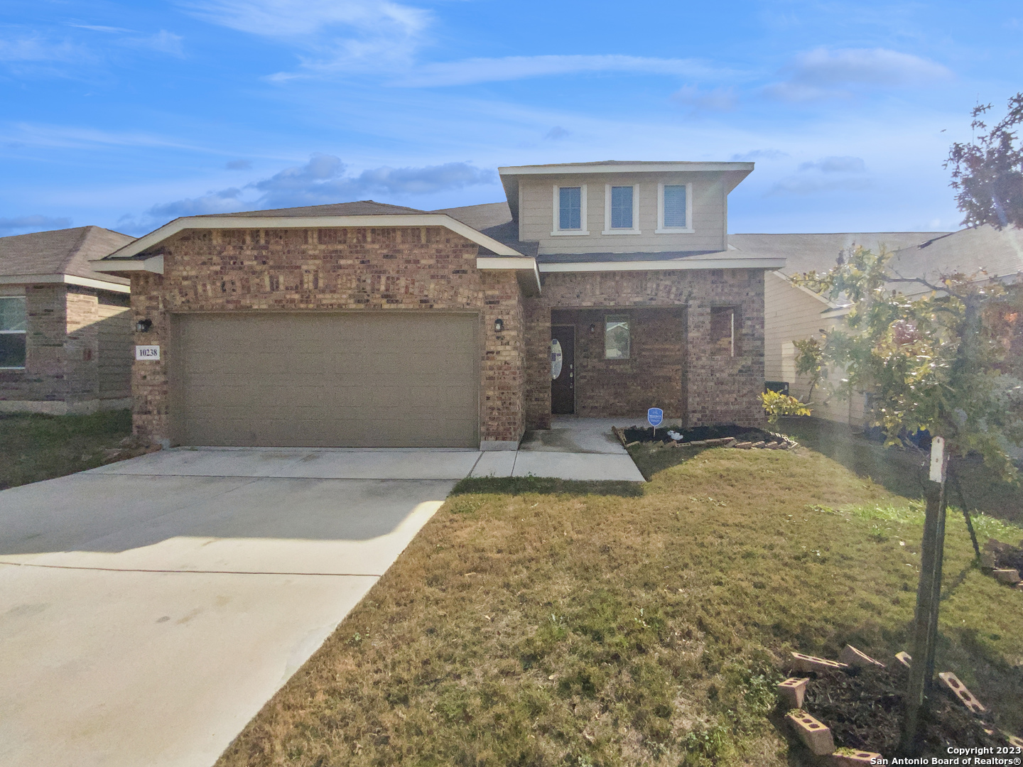 a front view of a house with a yard
