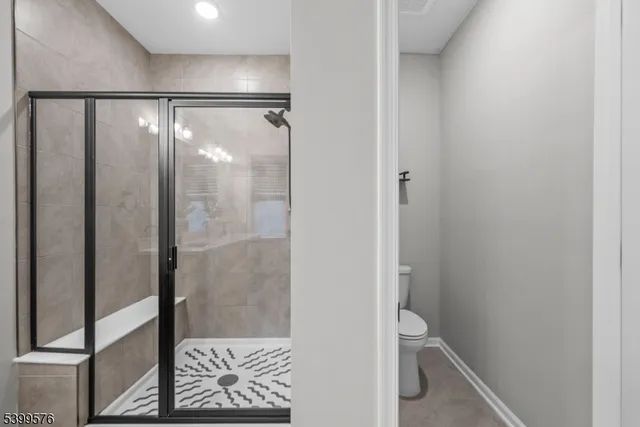 a bathroom with a glass shower door