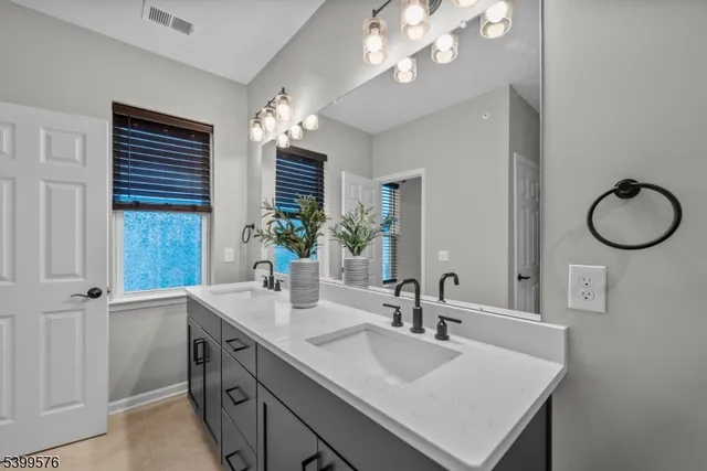 a bathroom with a sink double vanity and a mirror