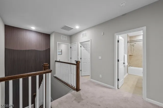a view of a hallway with wooden floor and entryway