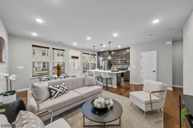 a living room with furniture kitchen view and a table