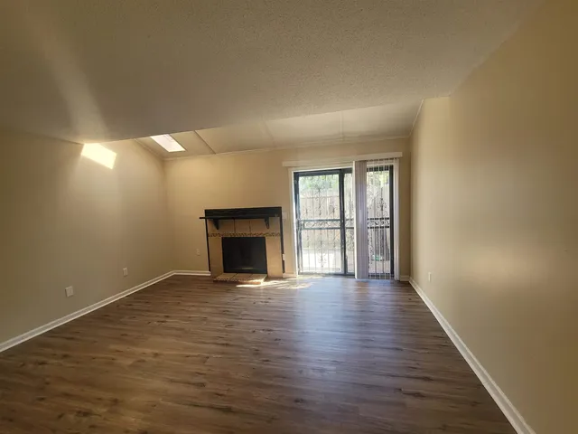 wooden floor in an empty room with a fireplace