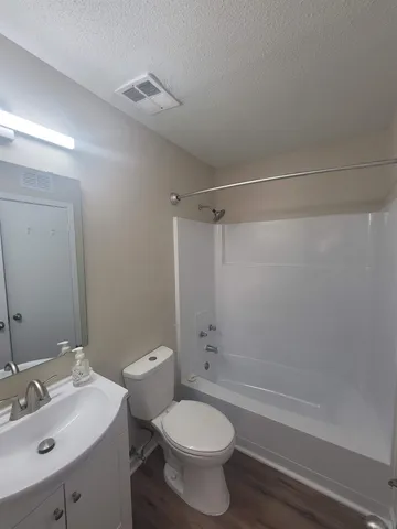 a bathroom with a sink mirror toilet and bathtub