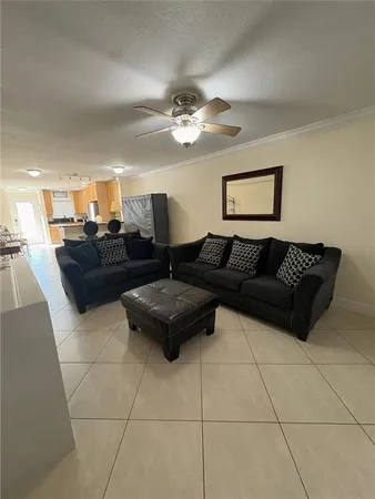 a kitchen with stainless steel appliances a stove a sink a dining table and chairs