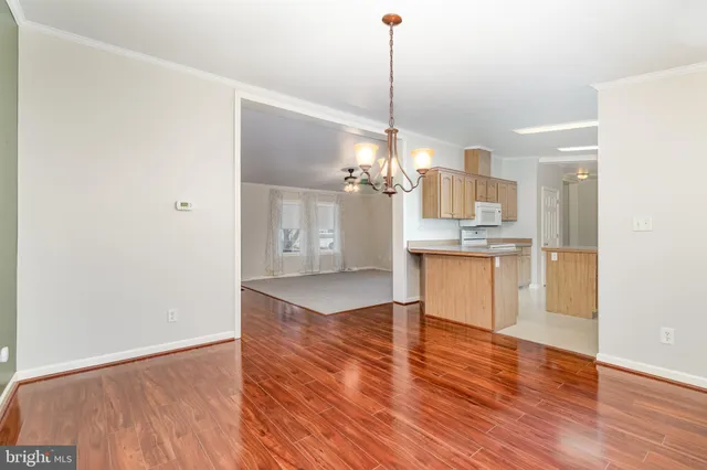 a view of a kitchen with a refrigerator sink and wooden floor