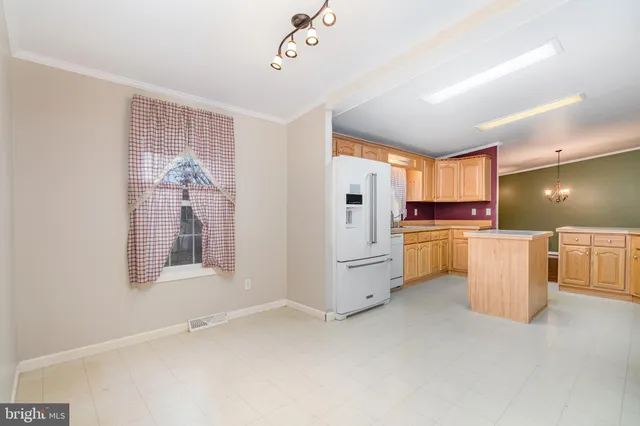 a kitchen with refrigerator and cabinets