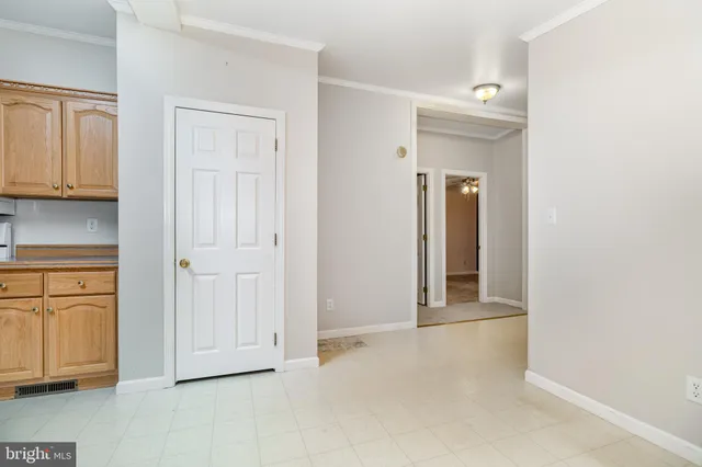 a view of a kitchen with a sink and cabinets