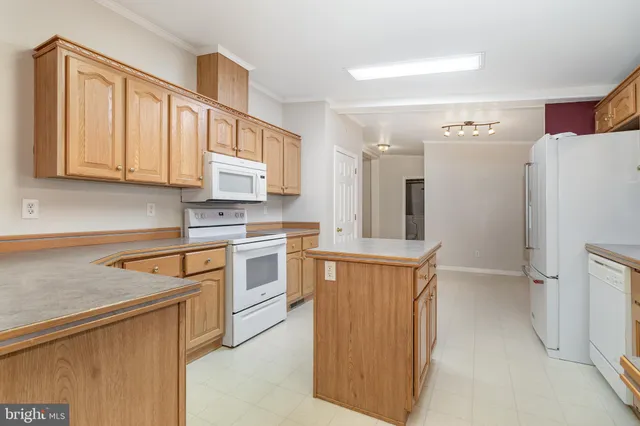 a kitchen with stainless steel appliances granite countertop a refrigerator sink and cabinets