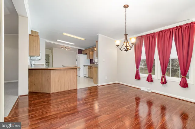 a view of a room with wooden floor and windows