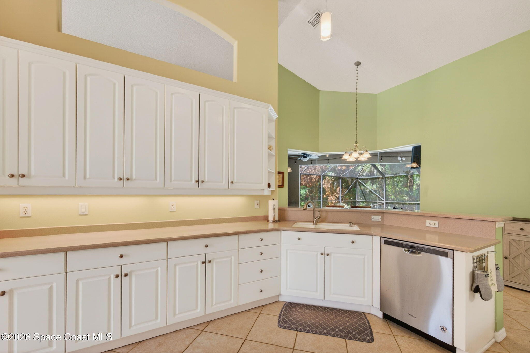 440 Mohawk Trail Merritt Island, FL 32953 - Photo 18 of 86 a kitchen with white cabinets and sink
