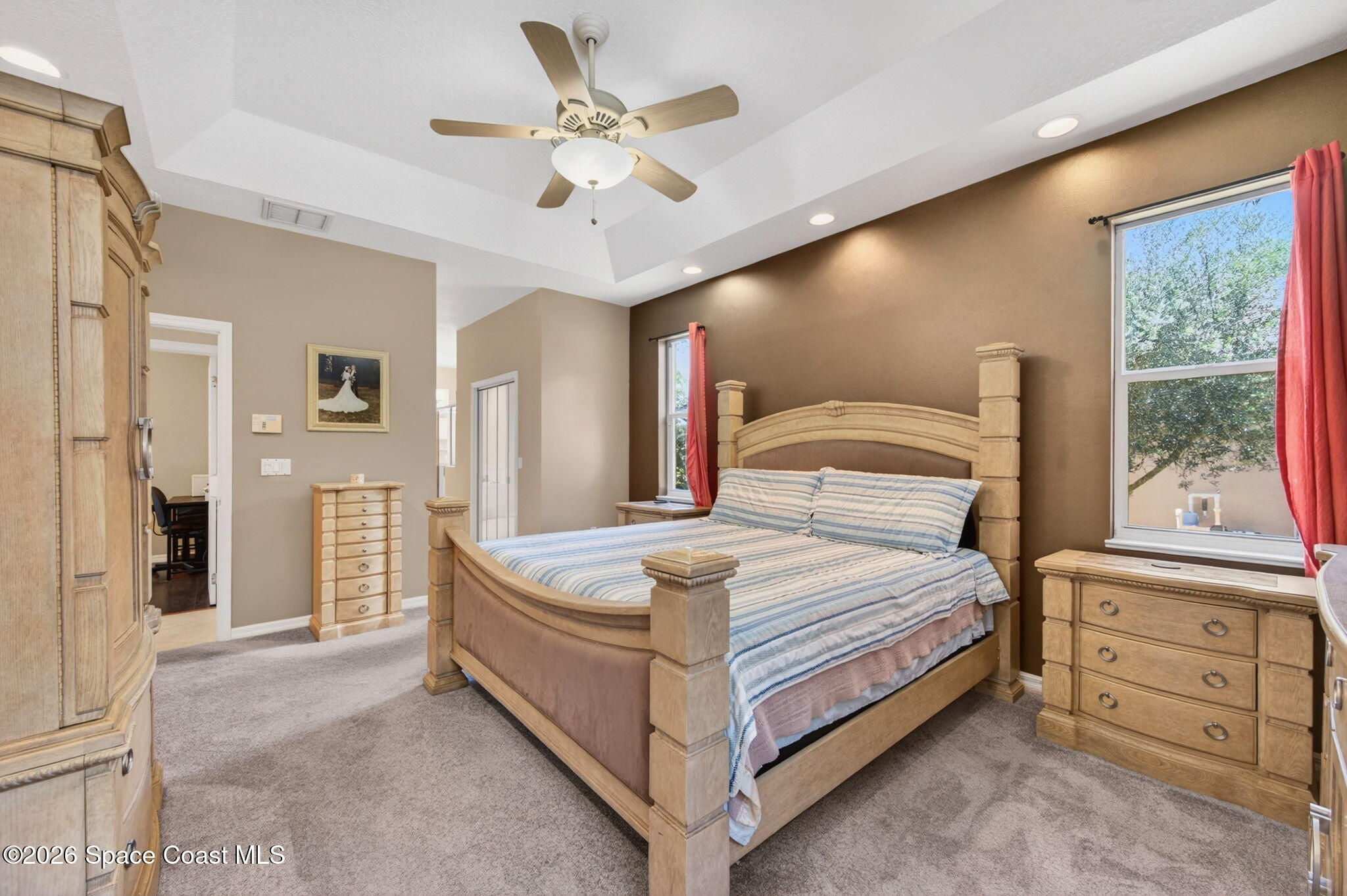 440 Mohawk Trail Merritt Island, FL 32953 - Photo 27 of 86 a bedroom with a large bed and a chandelier