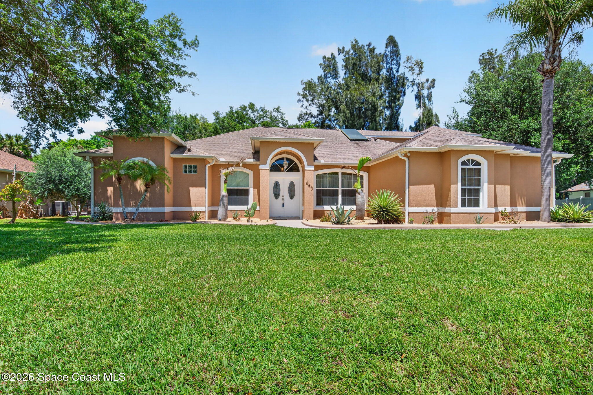 440 Mohawk Trail Merritt Island, FL 32953 - Photo 61 of 86 a front view of a house with a garden
