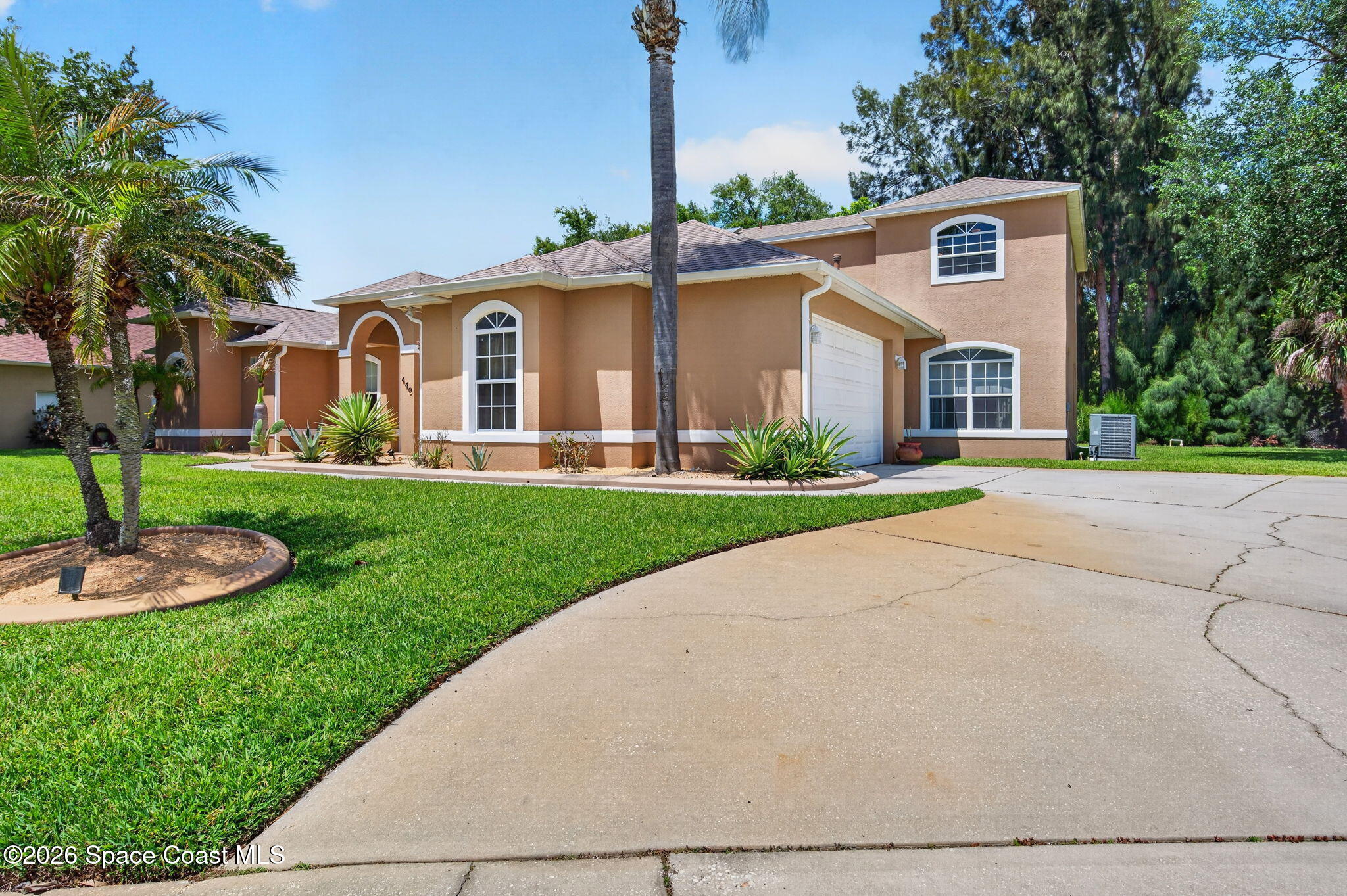 440 Mohawk Trail Merritt Island, FL 32953 - Photo 62 of 86 a front view of a house with a yard and garage