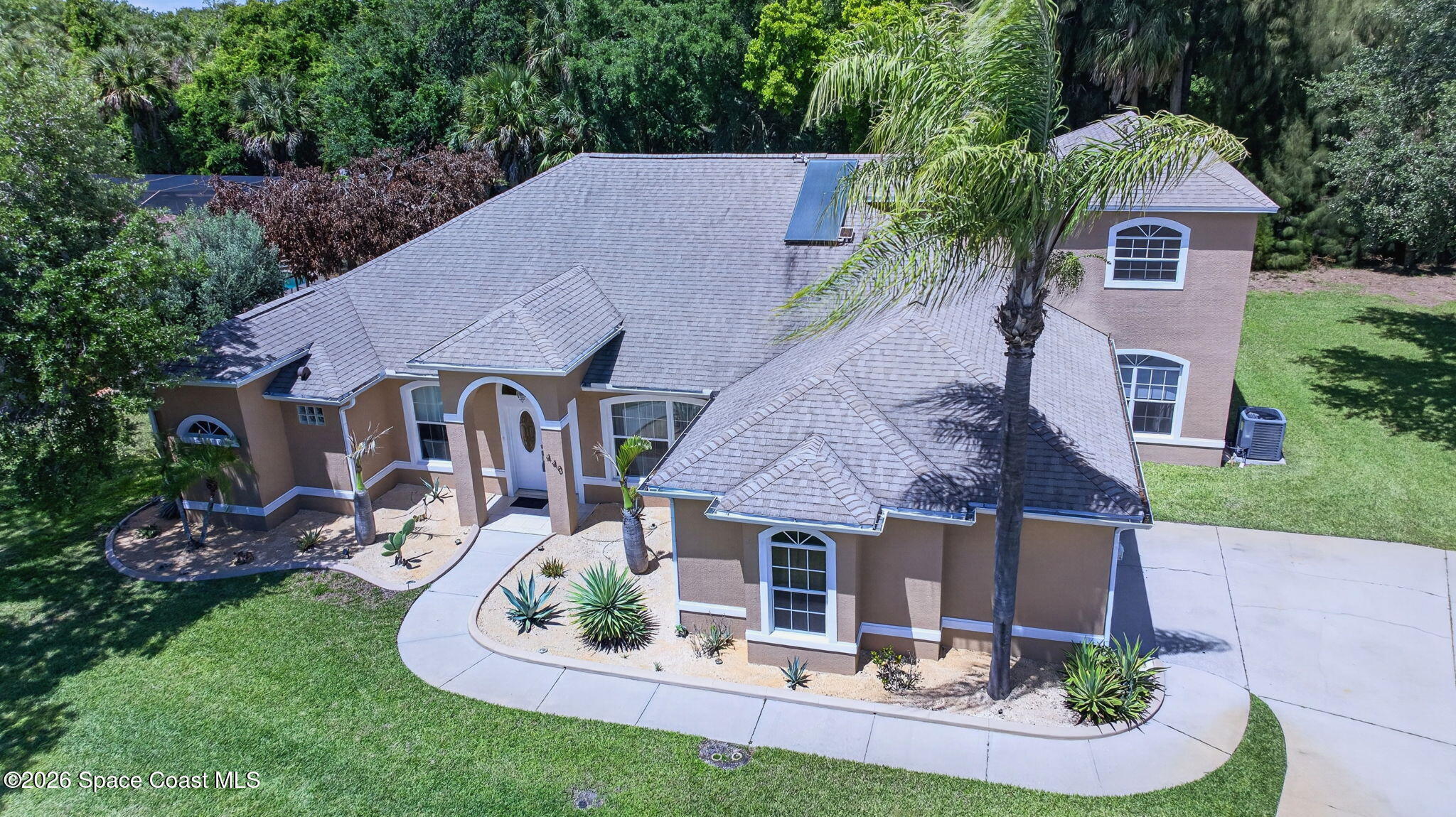 440 Mohawk Trail Merritt Island, FL 32953 - Photo 70 of 86 a aerial view of a house with table and chairs in a patio