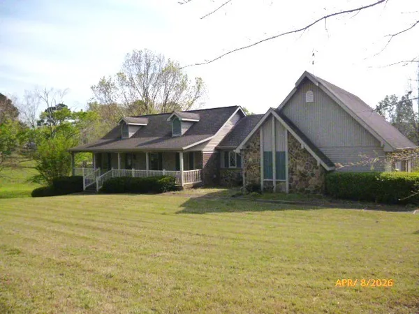 a front view of house with yard and trees