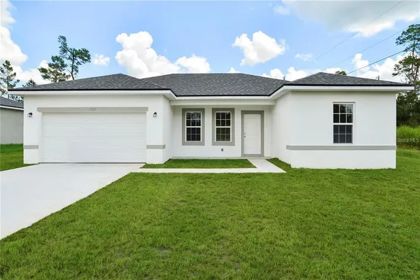 a view of a house with a backyard and a garden
