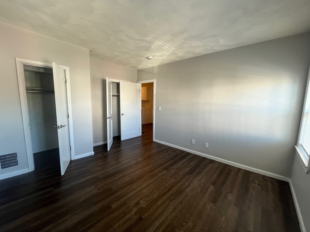 268 River Street, Unit 2 Waltham, MA 02453 - Photo 6 of 9 an empty room with wooden floor and closet
