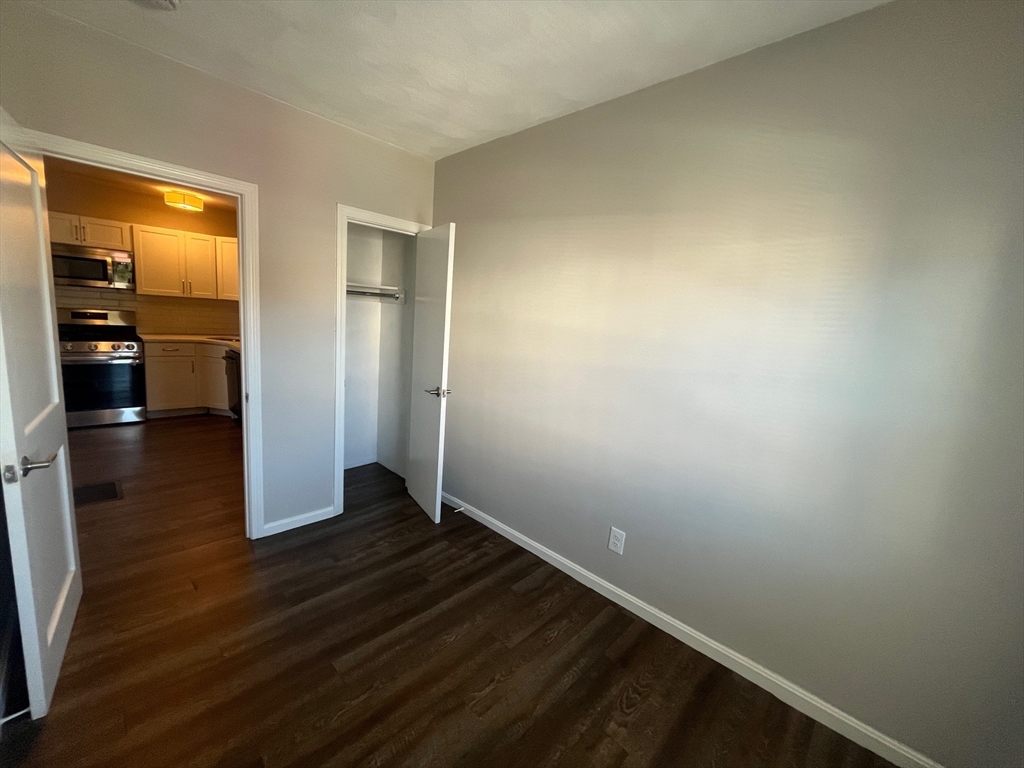 268 River Street, Unit 2 Waltham, MA 02453 - Photo 8 of 9 wooden floor in an empty room