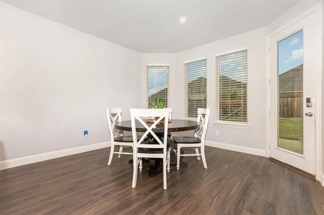 a dining room with furniture and wooden floor
