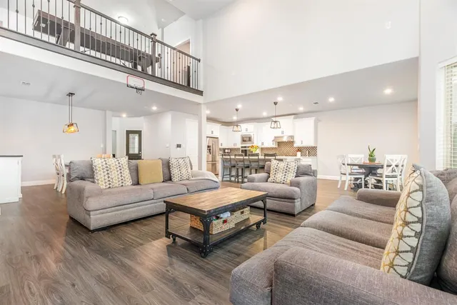 a living room with furniture and a view of kitchen