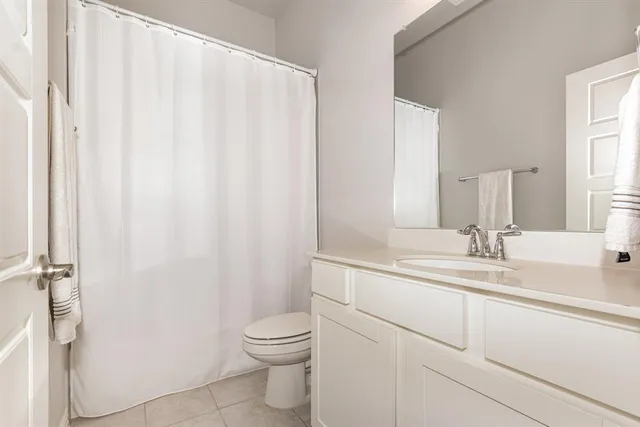 a large bed sitting in a bedroom next to a lamp