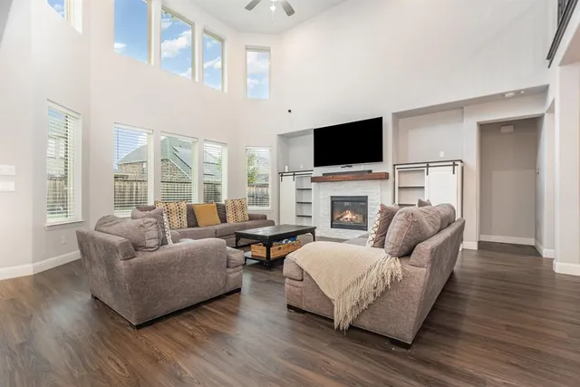 a living room with furniture a flat screen tv and a fireplace
