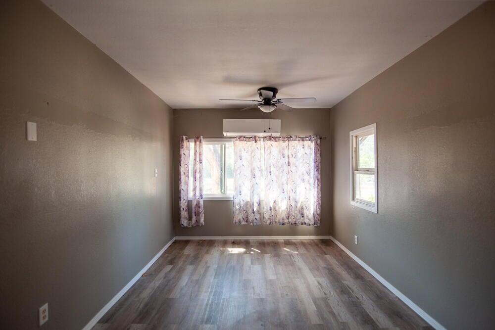 4778 North River Road Gold Hill, OR 97525 - Photo 11 of 15 an empty room with wooden floor and windows
