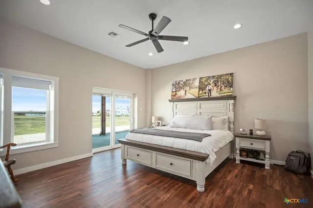 a bedroom with a bed and a large window