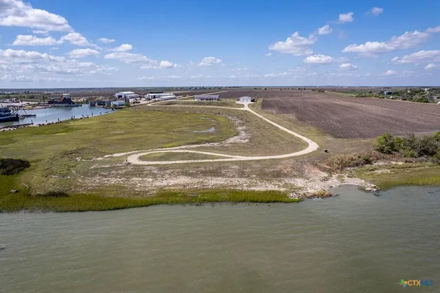 a view of a lake with houses in the background