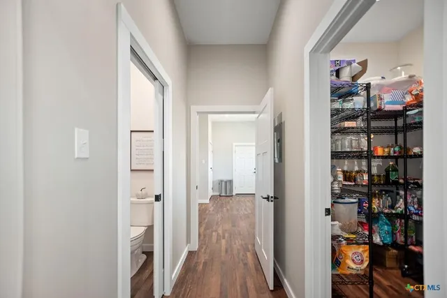 a view of a hallway with shelves