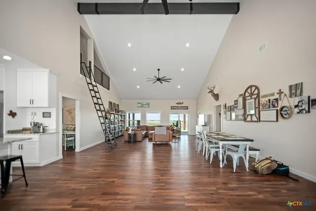 a living room with lots of furniture and kitchen view