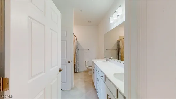 a bathroom with a sink a mirror and a shower