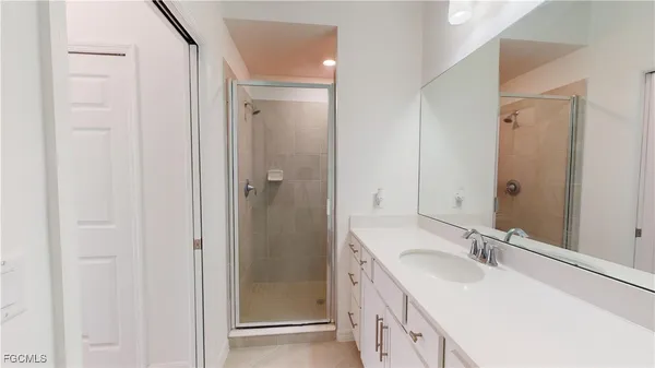a kitchen with white cabinets a sink a stove and a window