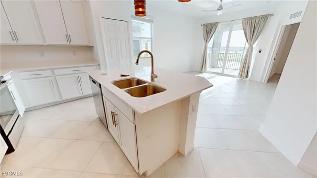 a kitchen with stainless steel appliances granite countertop a sink and a stove