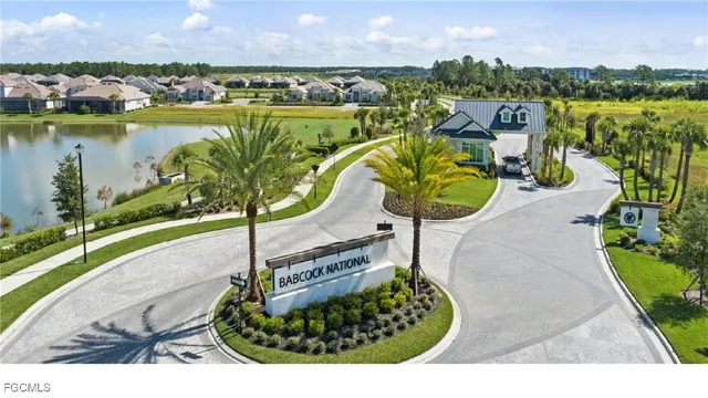 a view of the patio with dining table and chairs under an umbrella