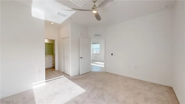 wooden floor in an empty room with a bathroom