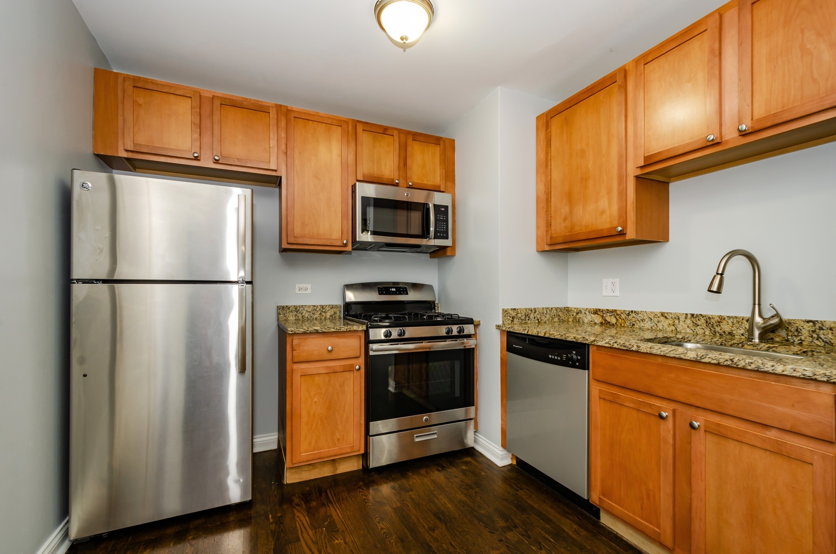 7616 North Marshfield Avenue, Unit 302 Chicago, IL 60626 - Photo 4 of 10 a kitchen with stainless steel appliances granite countertop a refrigerator stove top oven a sink and dishwasher
