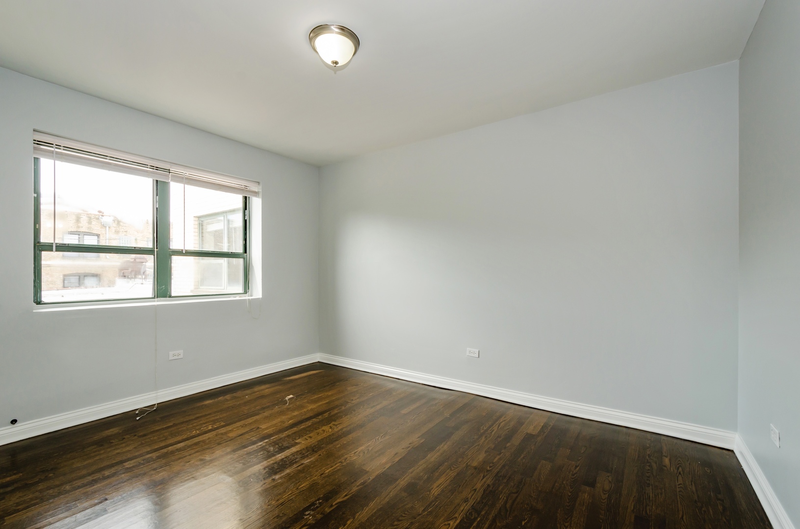 7616 North Marshfield Avenue, Unit 302 Chicago, IL 60626 - Photo 6 of 10 an empty room with wooden floor and windows