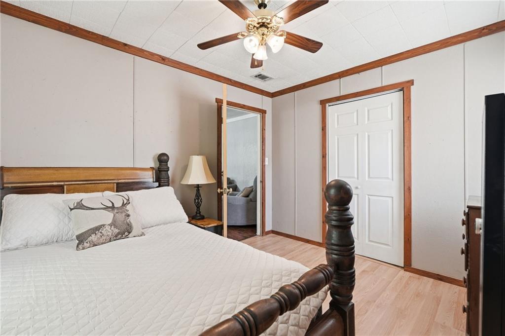 1709 Harrington Road Ball Ground, GA 30107 - Photo 26 of 46 a bedroom with a bed and a chandelier