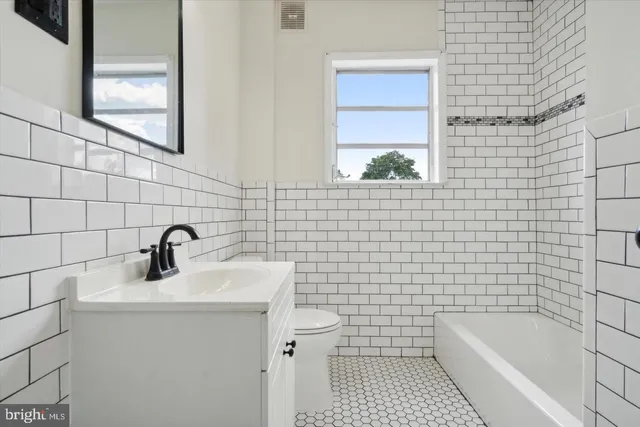 a bathroom with a sink a toilet and bathtub