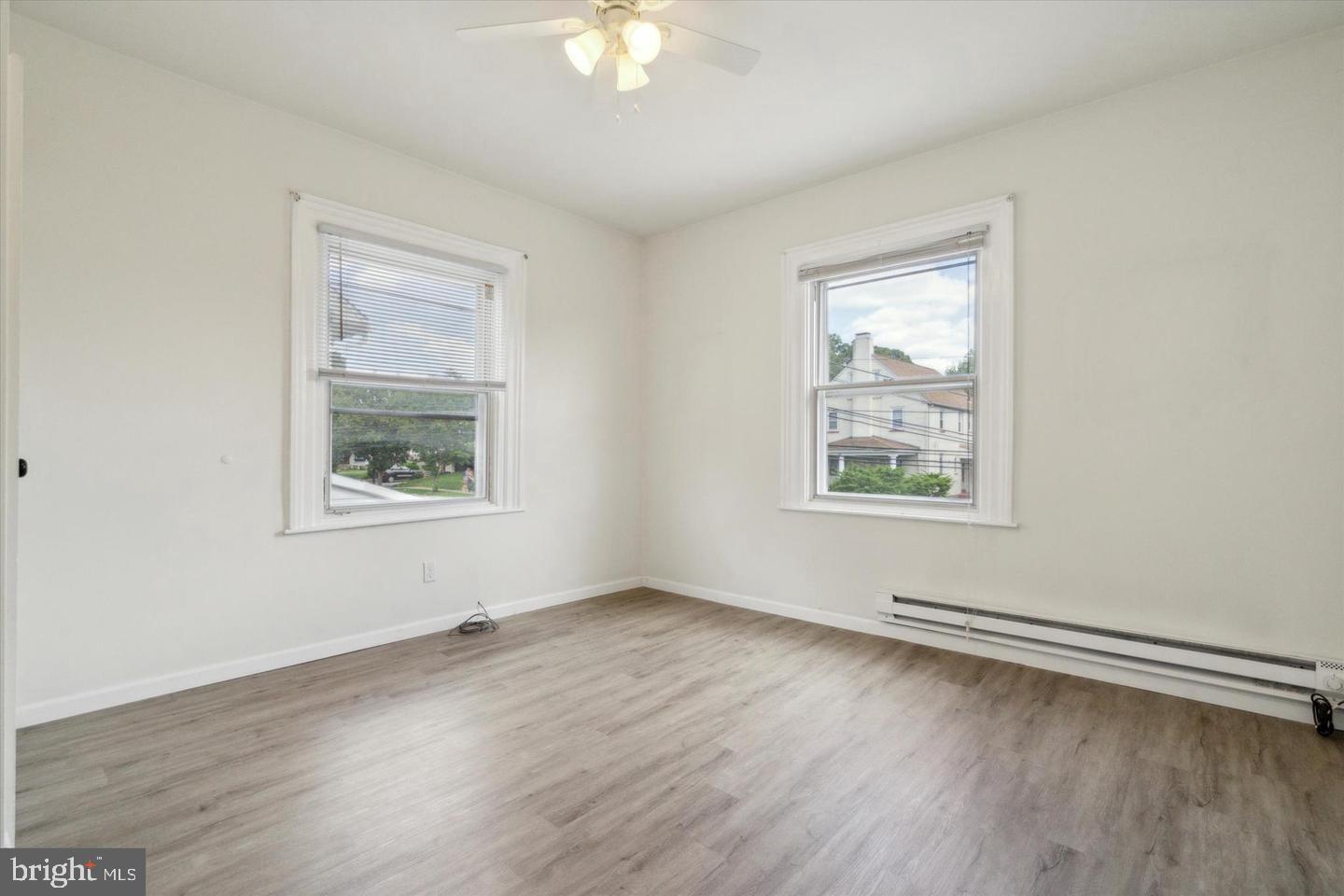 660 Loraine Street, Unit 2 Ardmore, PA 19003 - Photo 12 of 16 an empty room with wooden floor and windows