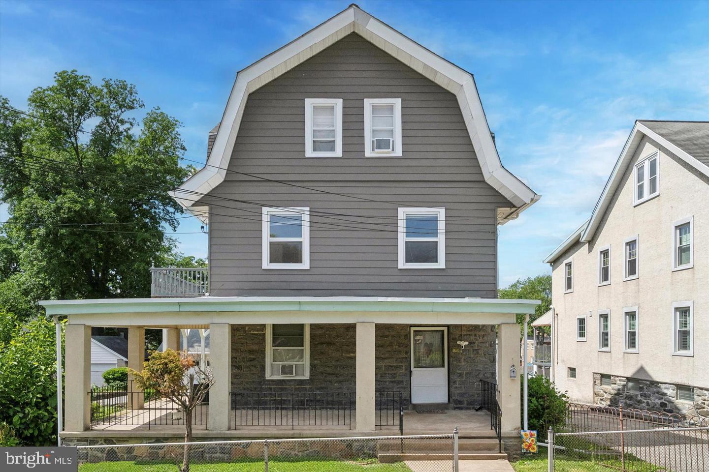660 Loraine Street, Unit 2 Ardmore, PA 19003 - Photo 2 of 16 a front view of a house with a yard