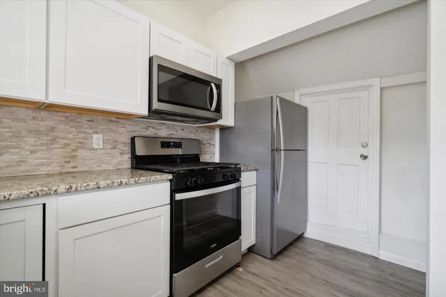 a kitchen with a stove microwave and sink