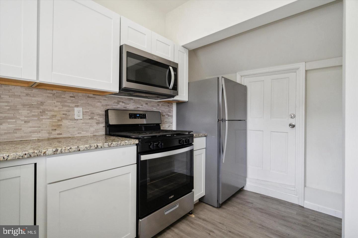 660 Loraine Street, Unit 2 Ardmore, PA 19003 - Photo 5 of 16 a kitchen with a stove microwave and sink