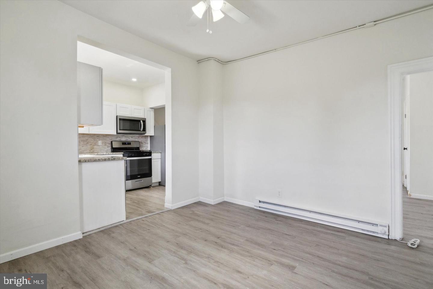 660 Loraine Street, Unit 2 Ardmore, PA 19003 - Photo 6 of 16 a kitchen with a refrigerator and a stove top oven