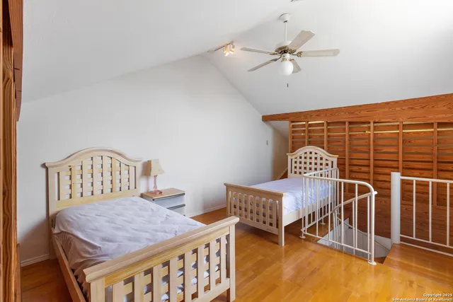 a bedroom with furniture and a ceiling fan