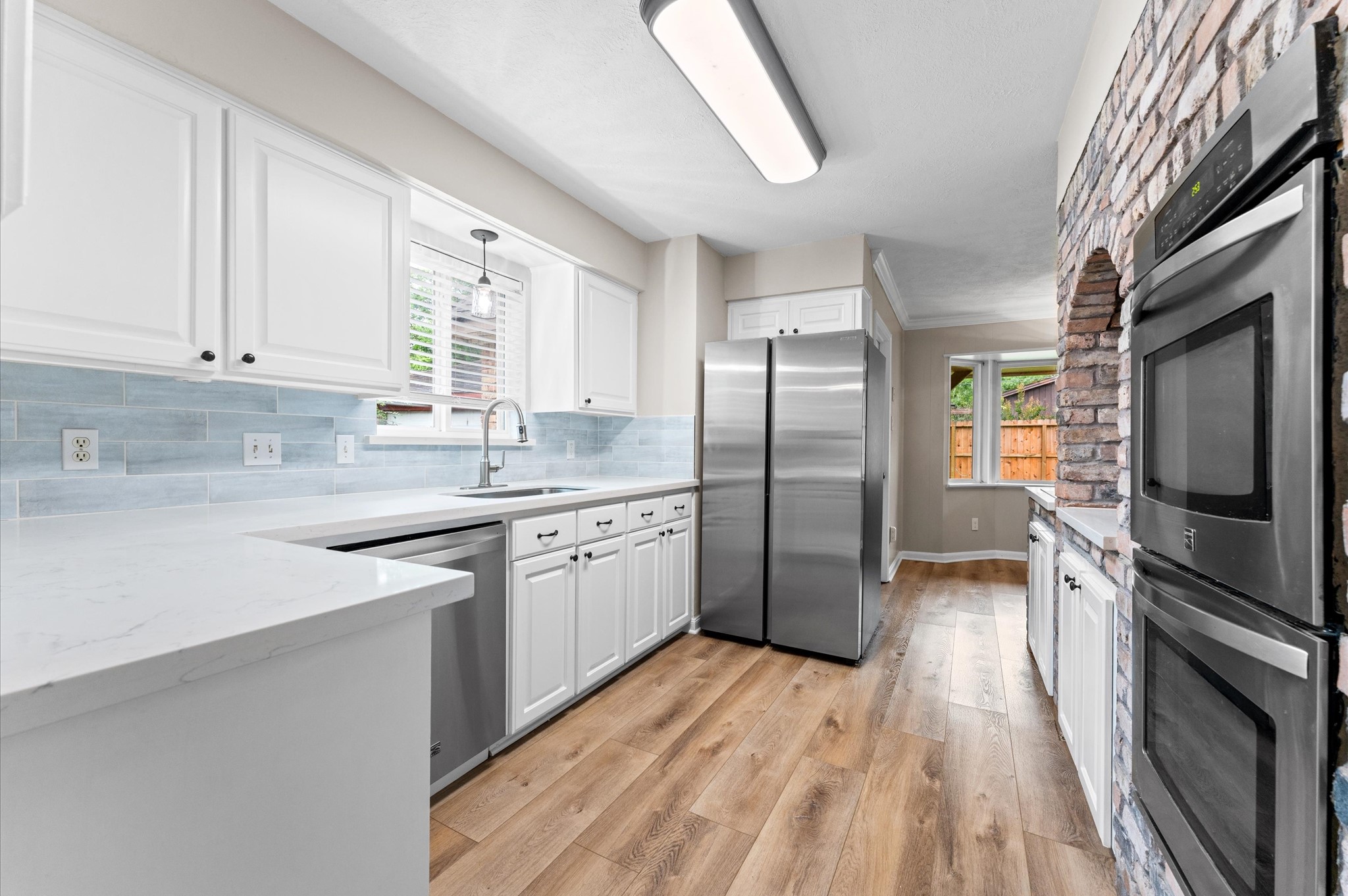 9407 Brooding Oak Circle Houston, TX 77096 - Photo 13 of 43 a kitchen with stainless steel appliances granite countertop a refrigerator a sink dishwasher a stove with wooden cabinets and floor
