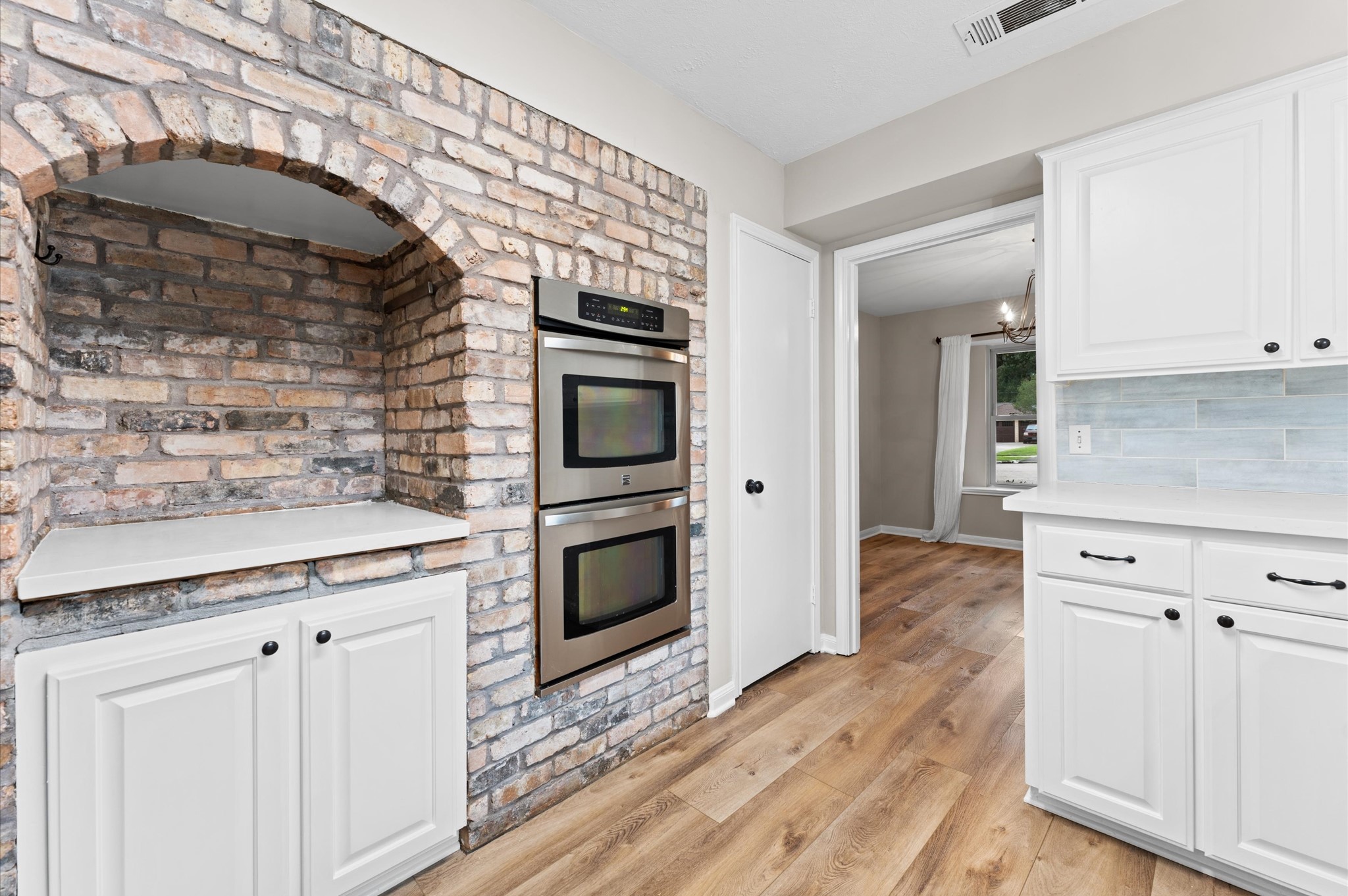 9407 Brooding Oak Circle Houston, TX 77096 - Photo 14 of 43 a kitchen with granite countertop a stove a sink and a microwave